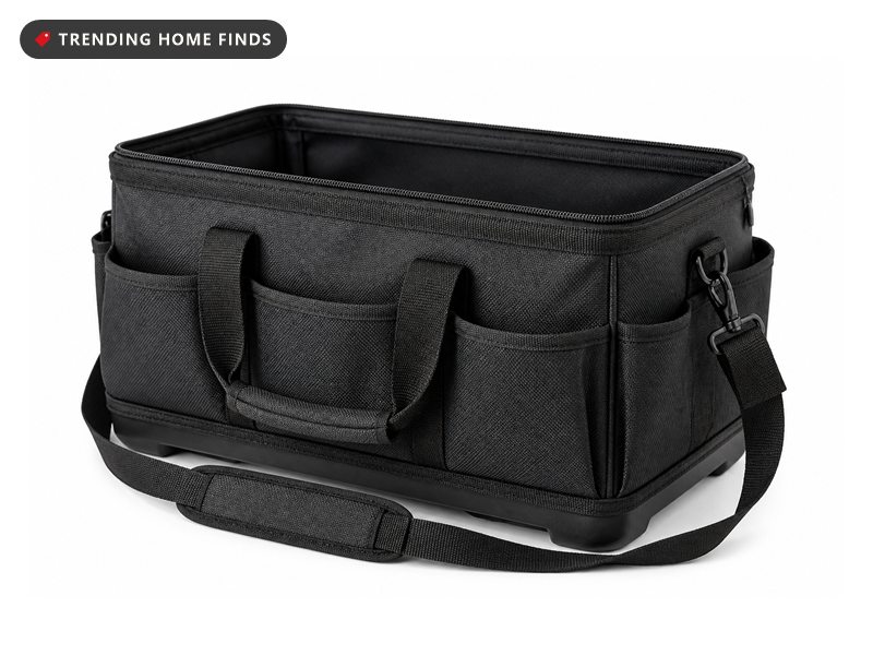 A charcoal polyester tool bag with a wide open mouth, a hard molded black base and a padded shoulder strap.