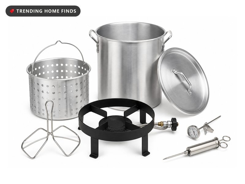 A turkey fryer kit with a black burner ring, an aluminum stockpot, a basket, a rack and a thermometer.