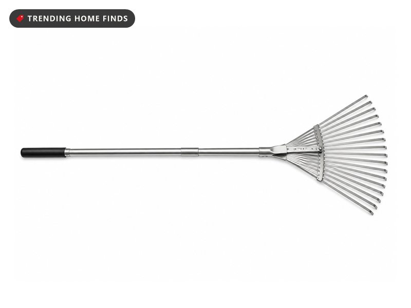 An adjustable leaf rake with a long silver telescoping handle and a fan shaped steel head.