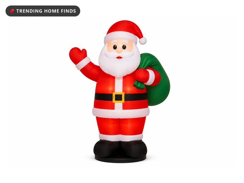 An eight foot inflatable Santa in a red suit with a green gift bag, lit from inside.