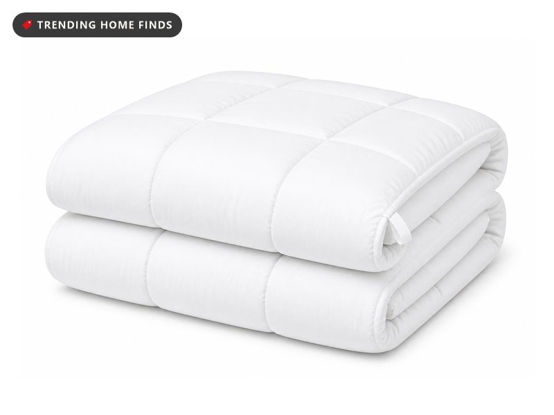 A white quilted down alternative comforter folded in thirds with a corner tab.