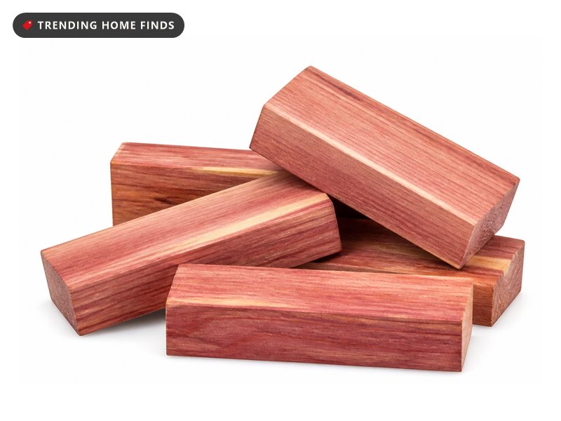 A small pile of smooth rectangular red cedar blocks with pale streaks in the grain.
