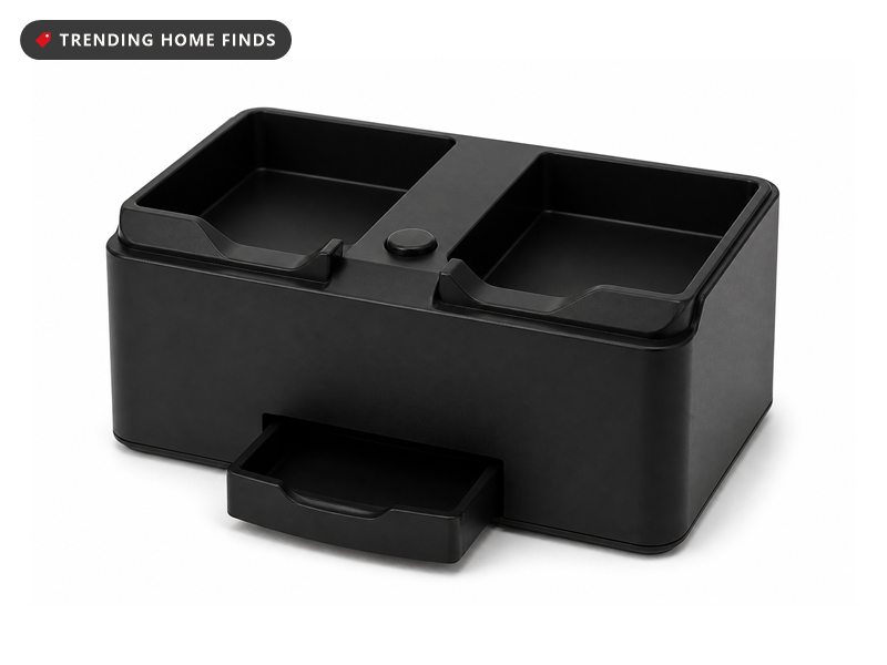 A compact matte black card shuffler with two card trays on top, a front tray and one round button.
