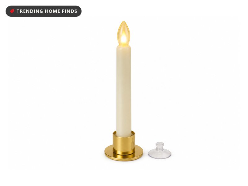 A flameless taper candle glowing amber in a small gold holder with a clear suction cup.