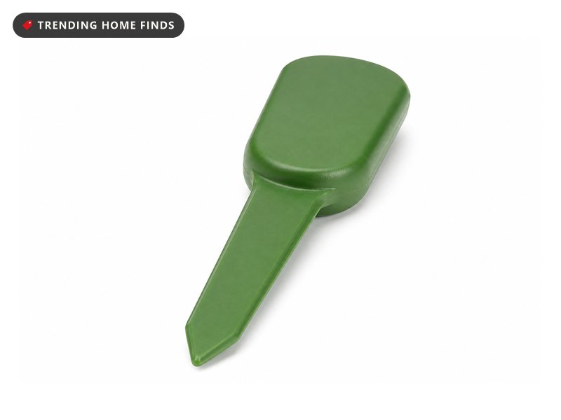 A slim green soil sensor with a small rounded cap and a flat narrow stake.