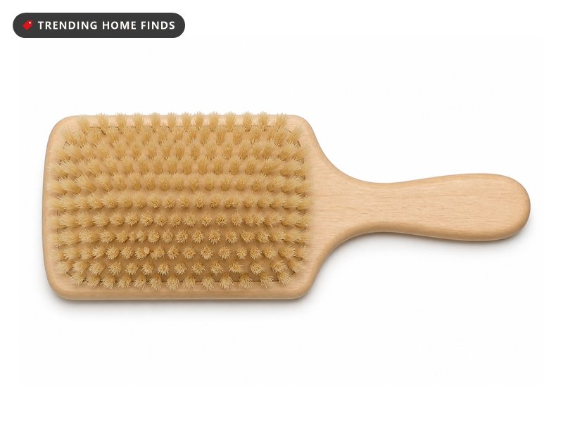 A flat square wooden paddle hair brush with soft pale boar bristles and a smooth wooden handle.