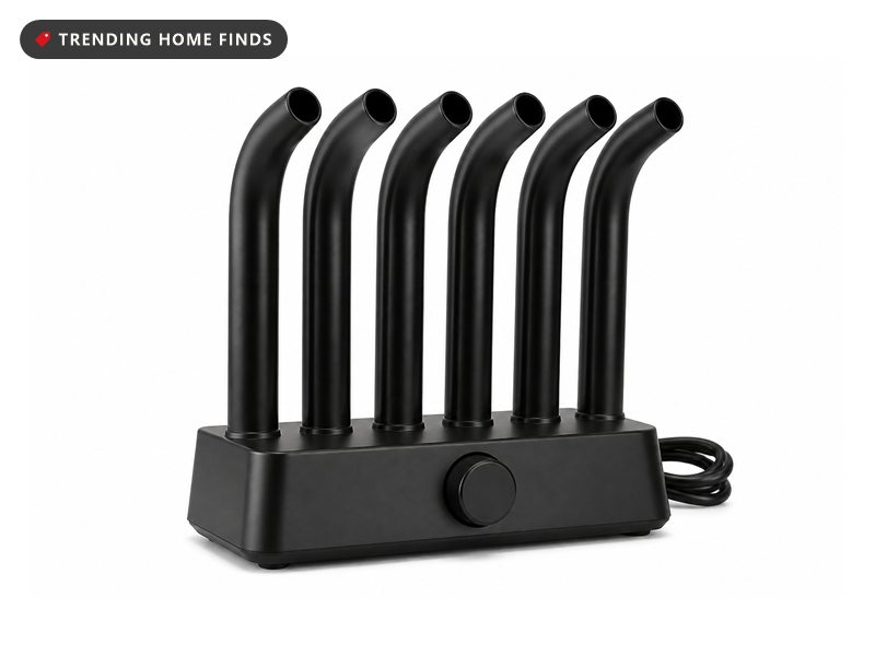 A black boot dryer with six upright tubes bending forward at the head and a plain round knob on the base.