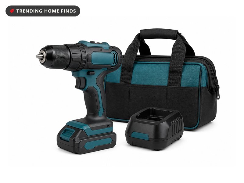 A dark gray cordless drill with teal accents beside a charger and a tool bag.