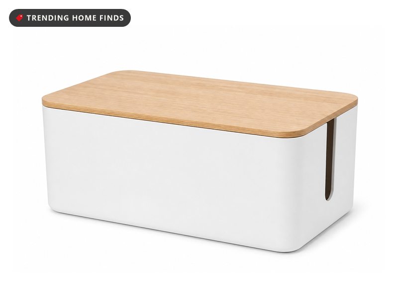 A white cable management box with a flat light wood lid and a cord slot at each end.