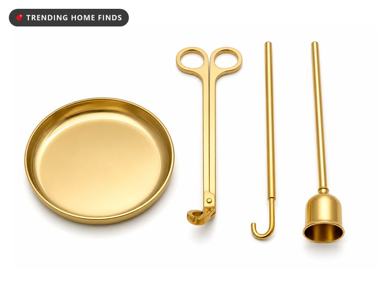 A gold wick trimmer, wick dipper and snuffer lying on a flat round gold tray.