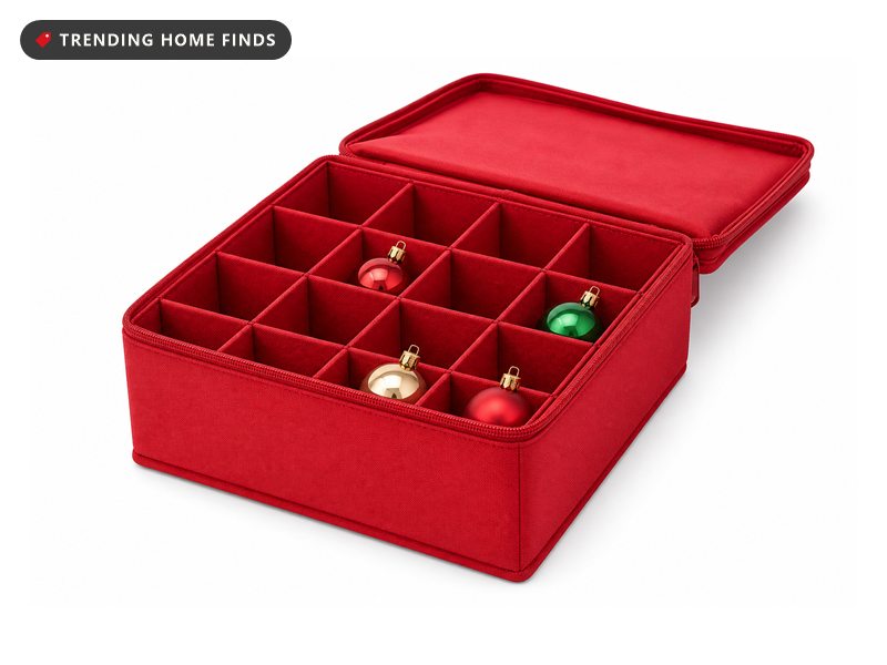 A red fabric ornament storage box with its lid folded back and a divided tray of cells.