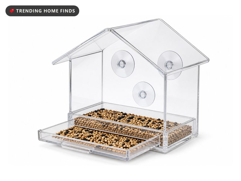 A clear acrylic bird feeder with a sloped roof, a slide out seed tray and suction cups.