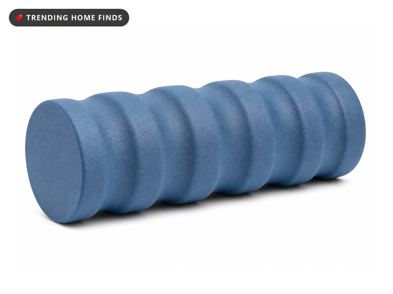 A blue firm foam roller with a notched, contoured profile instead of a smooth cylinder.