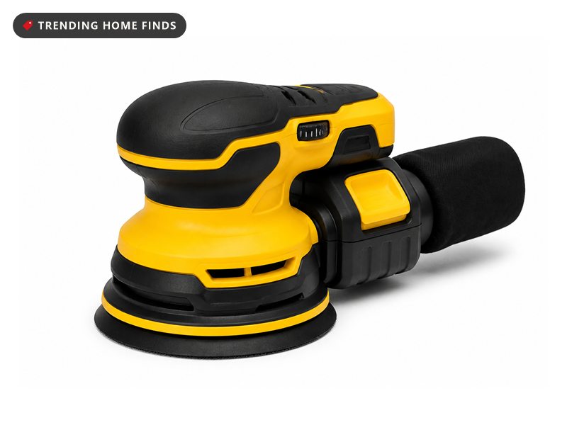 A yellow and black cordless random orbital sander with a round pad and a battery pack.
