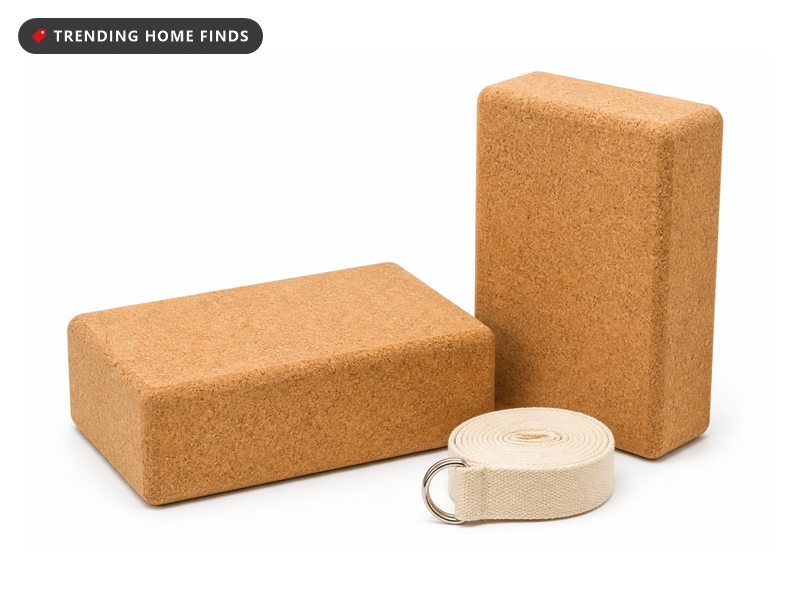 Two natural cork yoga blocks and a rolled strap with a metal D ring buckle.