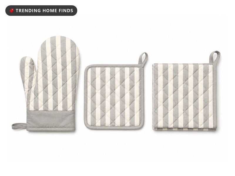 Three quilted cotton kitchen pieces in gray and cream stripe, an oven mitt with a wide cuff and two folded squares.