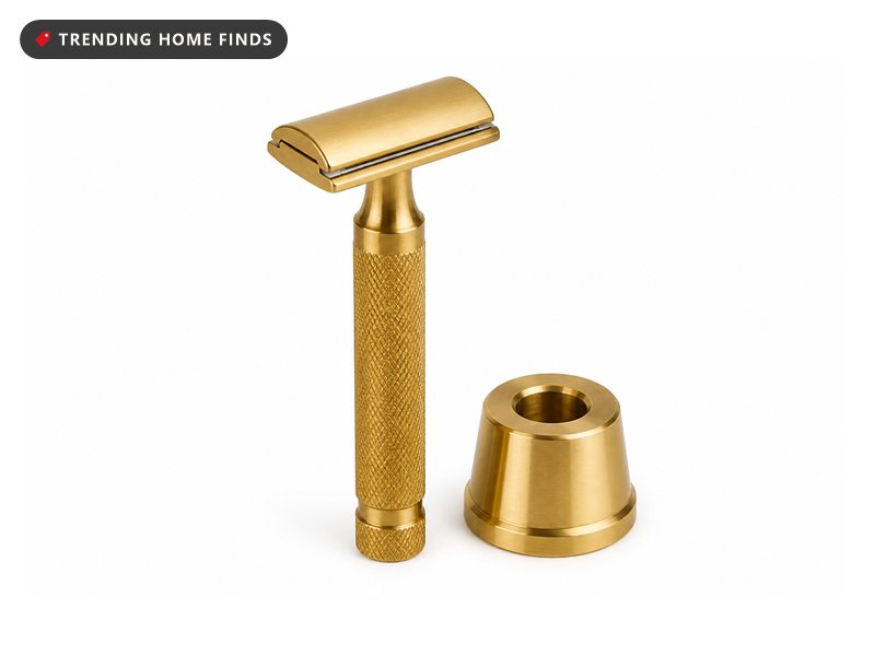A knurled solid brass double edge safety razor standing upright beside a matching brass stand.