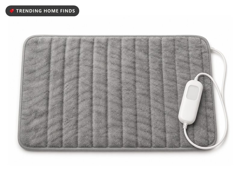A gray microplush electric heating pad with a faint tabby stripe and a small white hand controller.