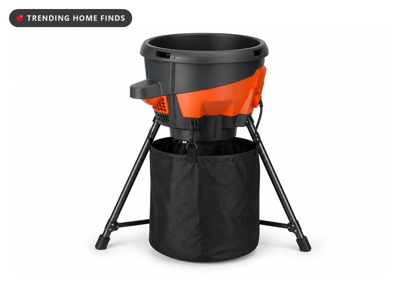 An electric leaf mulcher with a round open topped hopper on a folding steel stand and a collection bag.