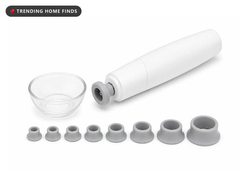 A slim white electric makeup brush spinner with a small clear bowl and spare rubber collars.