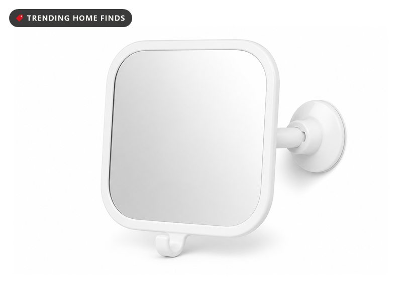 A white framed rounded square shower mirror on a swivel arm with a suction cup and a small hook.