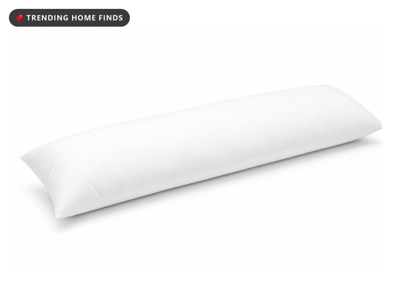 A long white body pillow lying flat, plump and evenly filled from end to end.