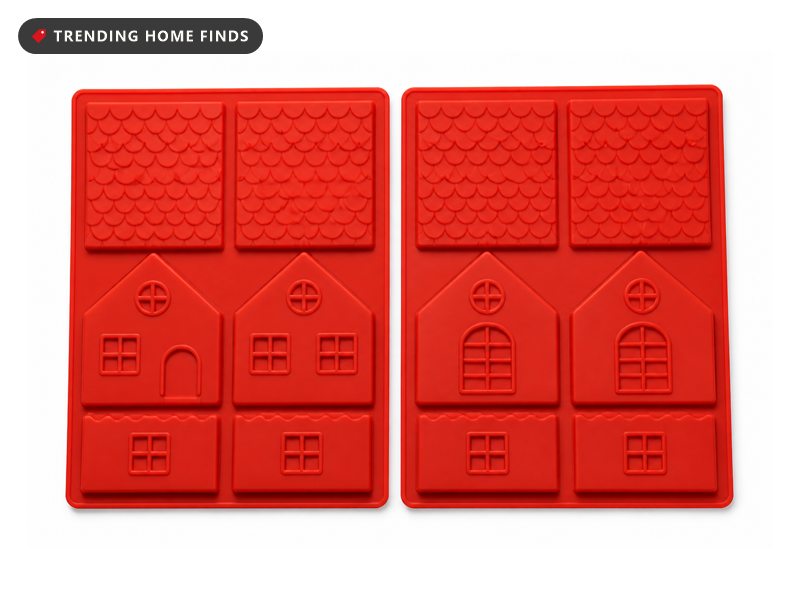 Two flat red silicone trays pressed with the roof and wall cavities of a gingerbread house.