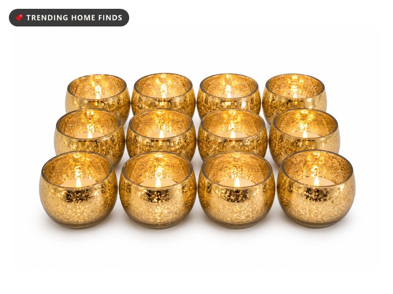 Twelve gold mercury glass votive holders with a speckled finish, each holding a lit tealight.