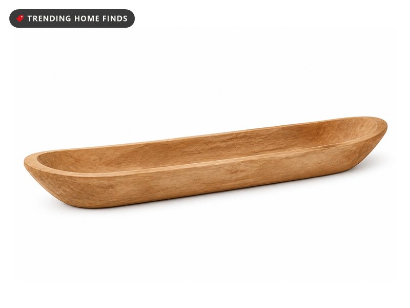 A long shallow hand carved wooden dough bowl with tapered ends.