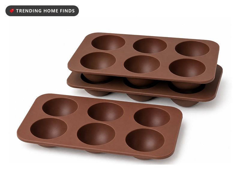 Three brown silicone mold trays, each with six round half sphere cavities in two rows.