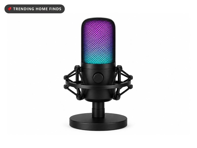 A USB condenser microphone in a black shock mount with its mesh body glowing purple and teal.