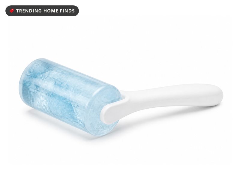 An ice roller with a clear roller head of frosty pale blue gel on a slim white handle.