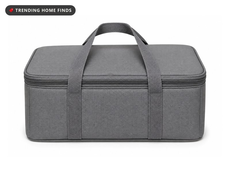 A gray insulated casserole carrier tote with two fabric handles and a zippered lid.
