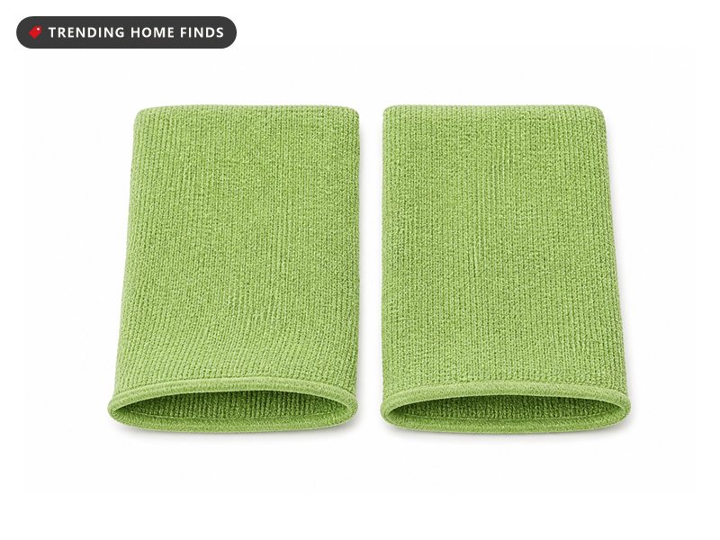 Two green viscose exfoliating mitts lying flat side by side with a fine woven texture.
