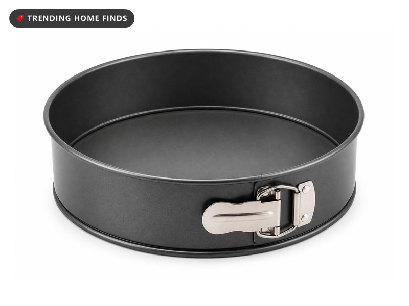 A dark gray nonstick springform pan with a flat round base and a tall side ring closed by a steel clasp.