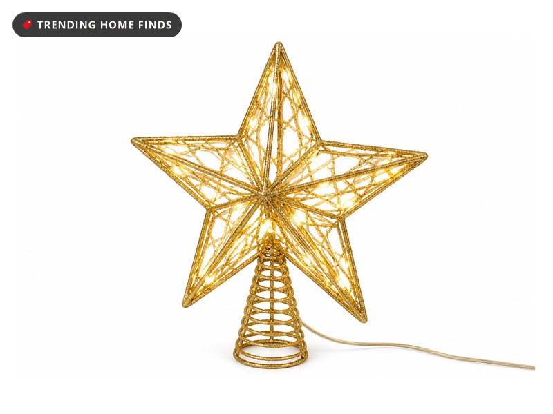 A gold glittered three dimensional star tree topper with an open wire frame and warm white bulbs lit inside.