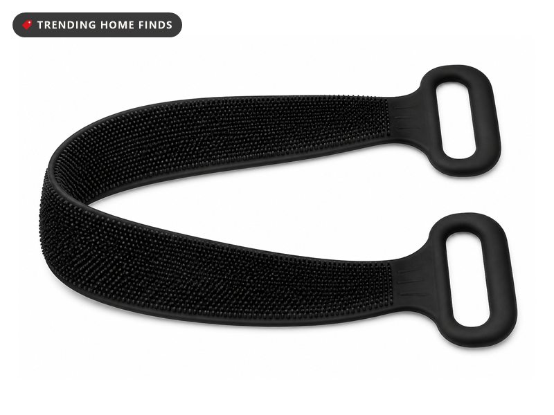 A long black silicone back scrubber strap with a textured face and loop handles.