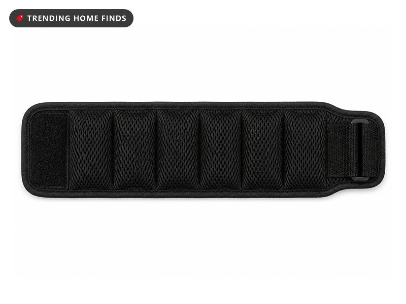 A black mesh magnetic wristband with a row of magnet pockets and an adjustable strap.