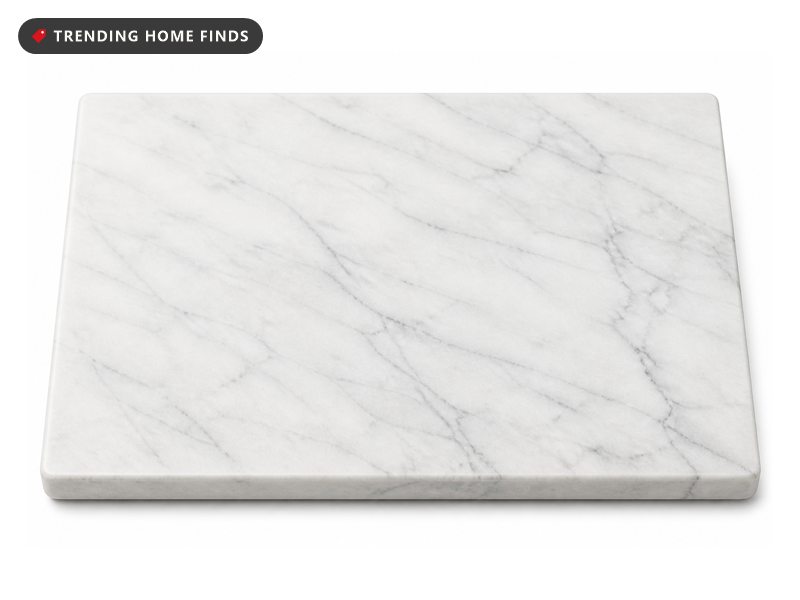 A thick rectangular white marble pastry board with soft gray veining and rounded edges.