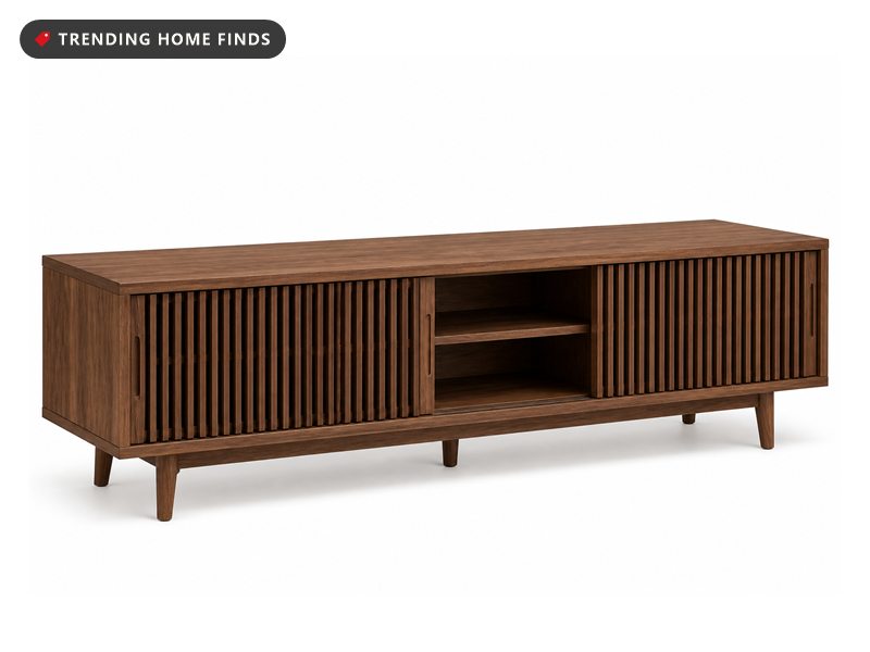 A long low walnut media console on tapered legs with slatted sliding doors and an adjustable shelf inside.