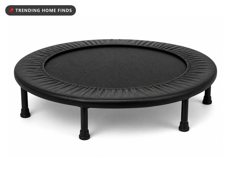 A round black mini trampoline on six short legs with a thick foam cover ring around the edge.