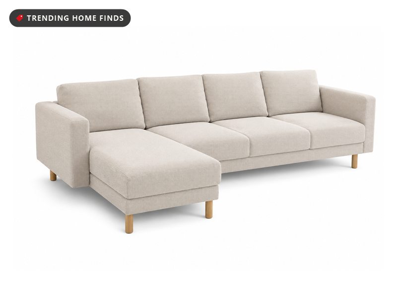 Beige textured slipcover fitted on a four-seat sectional sofa with a left-hand chaise and light wood legs