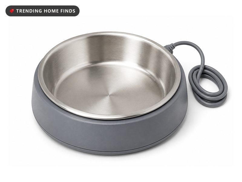 A round brushed stainless steel water bowl seated in a low gray base with a cord at the back.