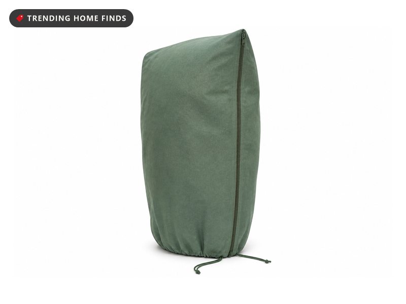 Four green non-woven plant frost cover bags, one shown open with its zipper and drawstring.