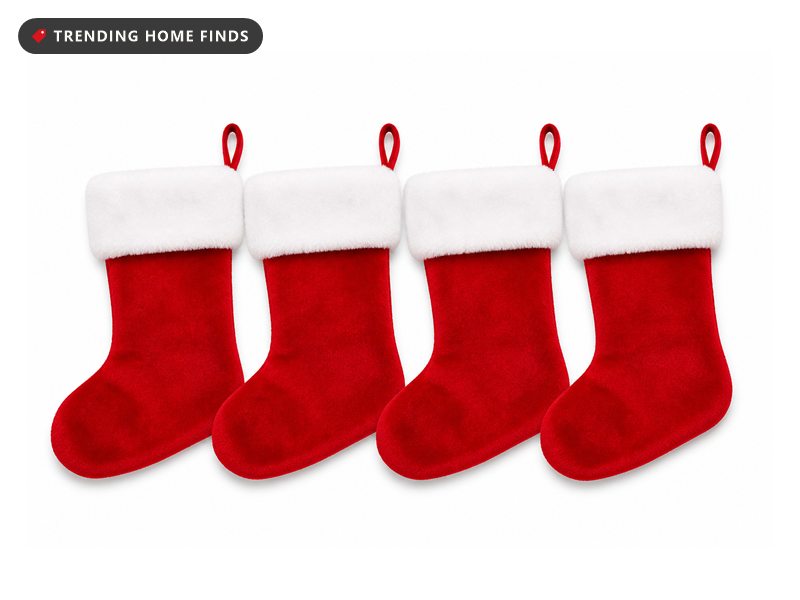Four red plush velvet Christmas stockings with deep white cuffs.