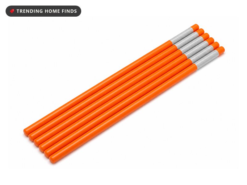 A bundle of orange fiberglass driveway markers with bands of silver reflective tape.