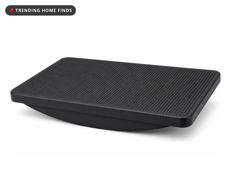 A black plastic rocker balance board with a textured top surface, seen at a slight angle.