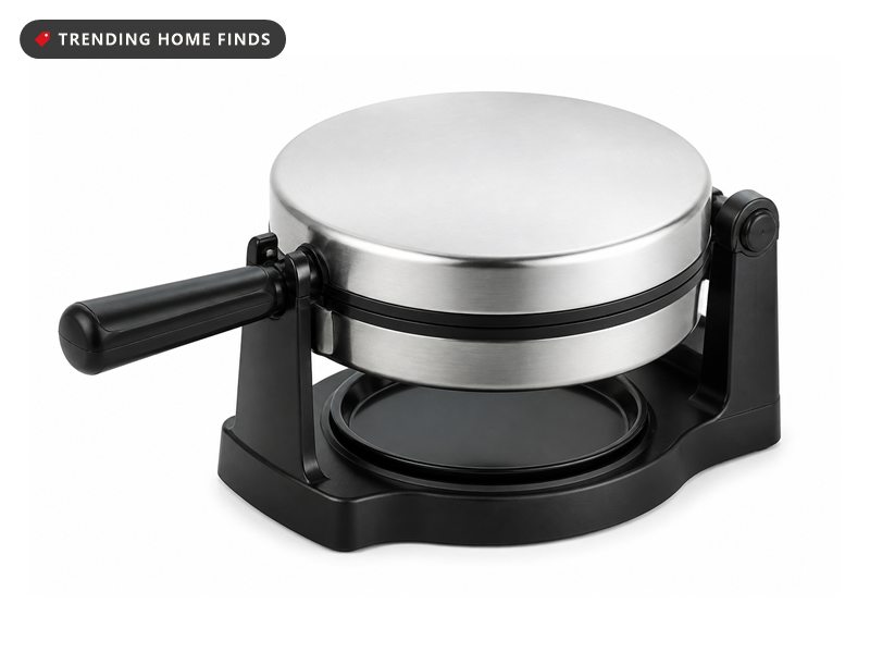 A round stainless steel and black rotating waffle iron held in a stand with a side hinge.