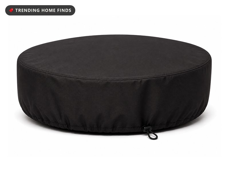 A round black fire pit cover shaped like a shallow drum with double stitched seams and a drawstring hem.