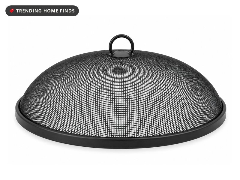 A round fire pit spark screen with a shallow black mesh dome and a looped center handle.